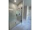 This newly constructed shower has an installed rain shower head, tiled walls, and a glass door at 222 Silvercrest Dr, Acworth, GA 30101