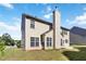 Exterior of two-story home with horizontal siding, a chimney, and plenty of windows at 310 Hammersmith Dr, Suwanee, GA 30024