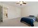 Neutral bedroom with ceiling fan, a window with blinds, carpeted floors, and closet space at 310 Hammersmith Dr, Suwanee, GA 30024