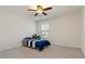 Neutral bedroom with ceiling fan, a window with blinds, carpeted floors, and closet space at 310 Hammersmith Dr, Suwanee, GA 30024