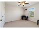 Neutral bedroom featuring a ceiling fan, carpeted floors, and a window with blinds and closet space at 310 Hammersmith Dr, Suwanee, GA 30024