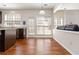 The kitchen area features wood floors and multiple windows for abundant natural light at 310 Hammersmith Dr, Suwanee, GA 30024
