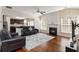 Open-concept living room featuring hardwood floors, fireplace, and seamless transition to the kitchen at 310 Hammersmith Dr, Suwanee, GA 30024