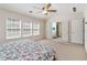 Main bedroom features windows and view to bathroom with tub at 310 Hammersmith Dr, Suwanee, GA 30024