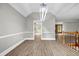 Open-concept dining area with modern lighting and seamless flow to other living spaces at 3232 Watson Mill Dr, Loganville, GA 30052