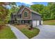 Charming home featuring stone accents, gray siding, and a well-manicured lawn at 3232 Watson Mill Dr, Loganville, GA 30052