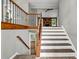 Foyer featuring hardwood floors and a staircase with wood and iron railing at 3232 Watson Mill Dr, Loganville, GA 30052