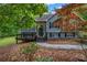 Beautiful home with stone and gray siding, a front porch, and lush landscaping at 3232 Watson Mill Dr, Loganville, GA 30052
