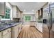 Kitchen with granite counters, stainless steel appliances, and wooden floors at 3232 Watson Mill Dr, Loganville, GA 30052