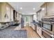 Modern kitchen boasting granite counters, stainless steel appliances, and custom cabinetry at 3232 Watson Mill Dr, Loganville, GA 30052