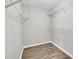 Functional walk-in closet with shelves, rod and wood-look floor at 3232 Watson Mill Dr, Loganville, GA 30052