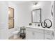 Well-lit bathroom with a modern vanity, toilet, and decorative artwork with a minimalist aesthetic at 371 Grant Se Cir # 1823, Atlanta, GA 30315