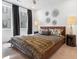 Stylish bedroom featuring dark wood accents, modern decor, and large windows for ample natural light at 371 Grant Se Cir # 1823, Atlanta, GA 30315