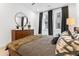 Bright bedroom showcasing a cozy bed, wood dresser, ample natural light from windows, and chic decor at 371 Grant Se Cir # 1823, Atlanta, GA 30315