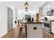 Stylish kitchen featuring white cabinets, an island with bar stools, and modern stainless steel appliances at 371 Grant Se Cir # 1823, Atlanta, GA 30315