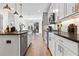 Open kitchen with stainless steel appliances, white cabinets, and a breakfast bar overlooking the dining area at 371 Grant Se Cir # 1823, Atlanta, GA 30315