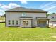 Spacious backyard featuring a covered patio and ample lawn space, perfect for outdoor entertainment at 4191 Hosch Reserve Dr, Buford, GA 30519