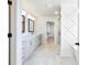 Modern bathroom with double vanity, marble floors, and glass-enclosed shower at 4191 Hosch Reserve Dr, Buford, GA 30519