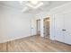 Bright bedroom featuring light hardwood floors, modern ceiling detail, closet, and ensuite access at 4191 Hosch Reserve Dr, Buford, GA 30519