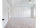 Spacious bedroom with paneling, tray ceiling, and neutral carpet at 4191 Hosch Reserve Dr, Buford, GA 30519