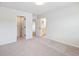 Bedroom featuring neutral walls, carpeting, and multiple doors to closet and Primary bathroom at 4191 Hosch Reserve Dr, Buford, GA 30519