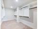 Walk-in closet featuring built-in shelving and neutral carpet at 4191 Hosch Reserve Dr, Buford, GA 30519