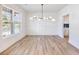 Bright dining room featuring modern light fixture and stunning wood-look floors at 4191 Hosch Reserve Dr, Buford, GA 30519