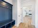 Hallway with a built-in blue hall tree and coat rack, enhancing entryway organization at 4191 Hosch Reserve Dr, Buford, GA 30519