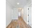 Clean hallway with modern flooring and white walls, providing a welcoming transition space at 4191 Hosch Reserve Dr, Buford, GA 30519