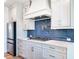 Modern kitchen featuring stainless steel appliances and a blue tile backsplash at 4191 Hosch Reserve Dr, Buford, GA 30519