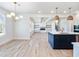 Spacious open concept floor plan with a kitchen island and elegant lighting fixtures at 4191 Hosch Reserve Dr, Buford, GA 30519