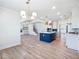 Open concept living area with kitchen island, fireplace, and staircase at 4191 Hosch Reserve Dr, Buford, GA 30519