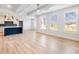 The open living space features a modern kitchen with an island, hardwood floors, and lots of natural light at 4191 Hosch Reserve Dr, Buford, GA 30519