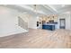 Open floor plan showcases the living space, kitchen with island, and staircase for a seamless flow at 4191 Hosch Reserve Dr, Buford, GA 30519