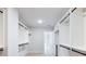A spacious walk-in closet with white built-in shelves and rods, providing ample storage and organization at 4191 Hosch Reserve Dr, Buford, GA 30519