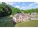 Aerial view of this attractive home, featuring manicured lawn and landscaping, with a long private driveway at 423 Blackbird Way, Hampton, GA 30228