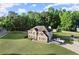 Aerial view of an attractive suburban home with a lush green yard and ample parking on its private driveway at 423 Blackbird Way, Hampton, GA 30228
