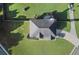 Aerial view of the property showing the house, a large yard, driveway and neighborhood at 423 Blackbird Way, Hampton, GA 30228