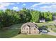 Aerial view of home with fenced backyard, basketball court and trampoline in a treed neighborhood at 423 Blackbird Way, Hampton, GA 30228