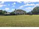Beautifully landscaped backyard with a huge grassy area and a full perimeter fence, perfect for outdoor activities at 423 Blackbird Way, Hampton, GA 30228