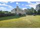 Expansive backyard featuring a large grass area, full perimeter fence, and well maintained landscaping at 423 Blackbird Way, Hampton, GA 30228