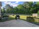 A backyard featuring a grill, a large lawn, and a storage shed at 423 Blackbird Way, Hampton, GA 30228