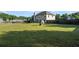 This generous backyard is fenced in, has a small playhouse and ample green space for Gathering activities at 423 Blackbird Way, Hampton, GA 30228