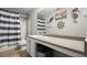 Charming bathroom with nautical decor, features a spacious countertop and shower with striped curtain at 423 Blackbird Way, Hampton, GA 30228
