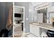 A modern bathroom with stylish fixtures, a large mirror, and a view into the primary bedroom at 423 Blackbird Way, Hampton, GA 30228