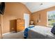 Cozy bedroom featuring a dresser and a decorative chair near a window with views at 423 Blackbird Way, Hampton, GA 30228