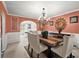 Formal dining room featuring chandelier, wainscoting and an archway at 423 Blackbird Way, Hampton, GA 30228
