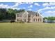 Beautiful two-story brick home featuring a spacious front yard and inviting curb appeal at 423 Blackbird Way, Hampton, GA 30228