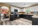 Modern kitchen with granite countertops, stainless steel appliances, and updated flooring at 423 Blackbird Way, Hampton, GA 30228