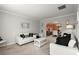 Bright living room with white sofas, neutral walls, and decorative accents at 423 Blackbird Way, Hampton, GA 30228